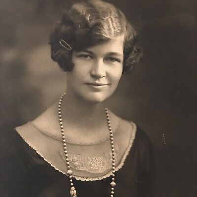 a flapper portrait, adorned with pearls